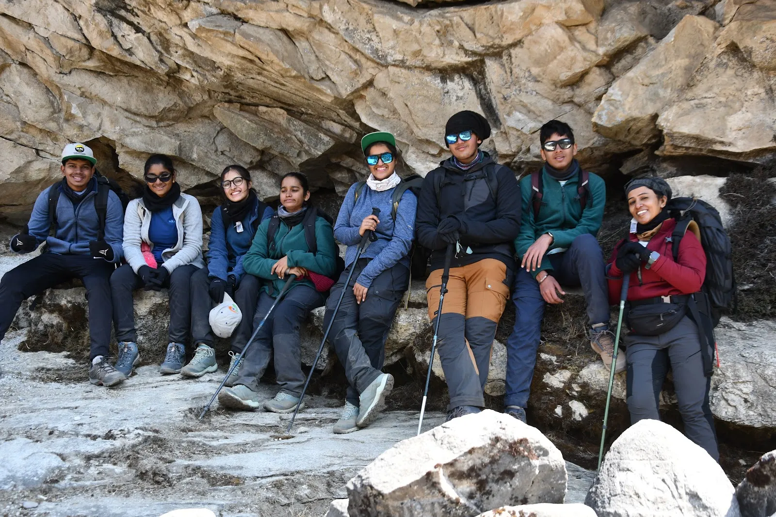 Sacred Heart students resting on rocks during the Everest Base Camp trek