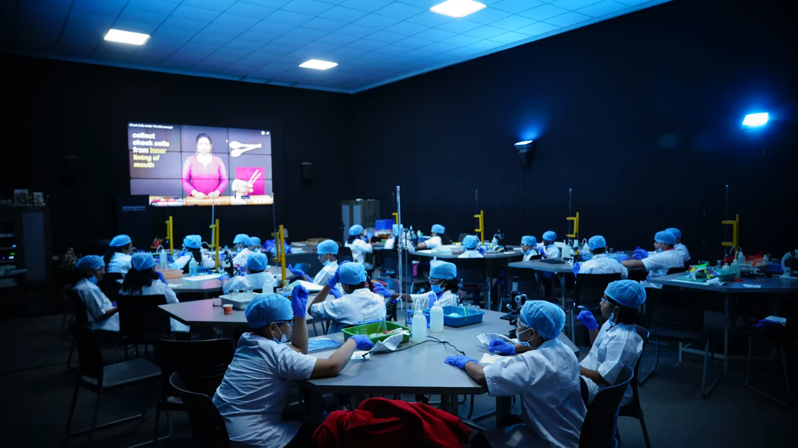Students watching a science presentation during a Biomimicry session