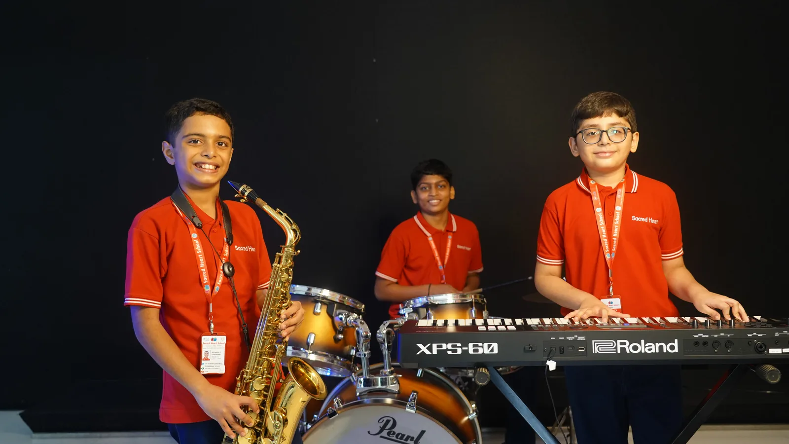 Students playing saxophone, drums and keyboard in the Music elective