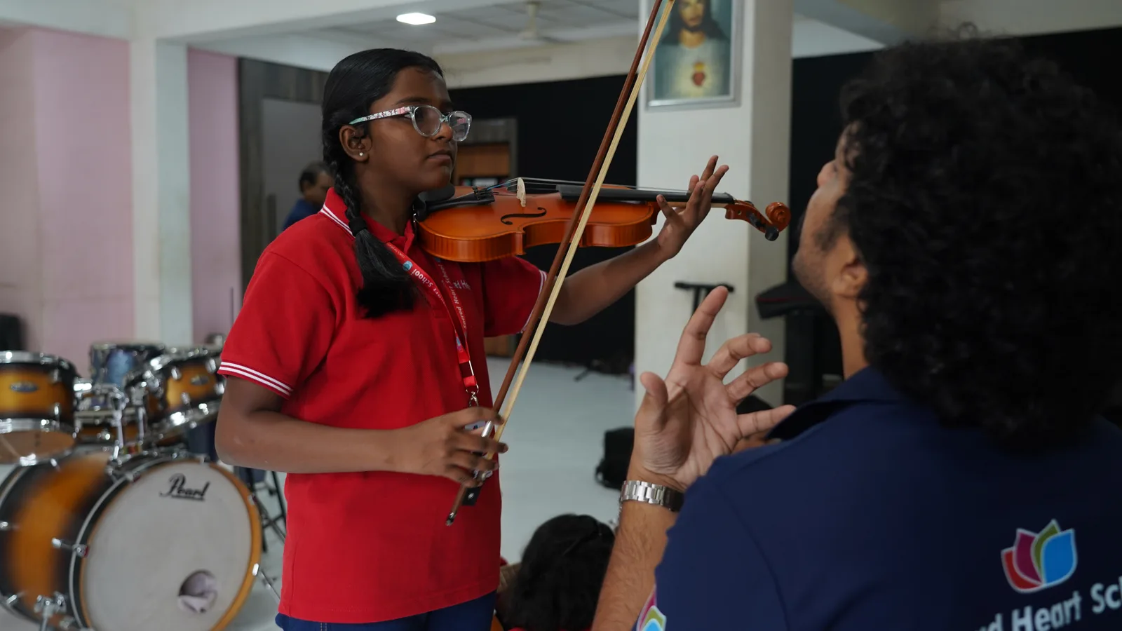 A student playing the violin during a music lesson