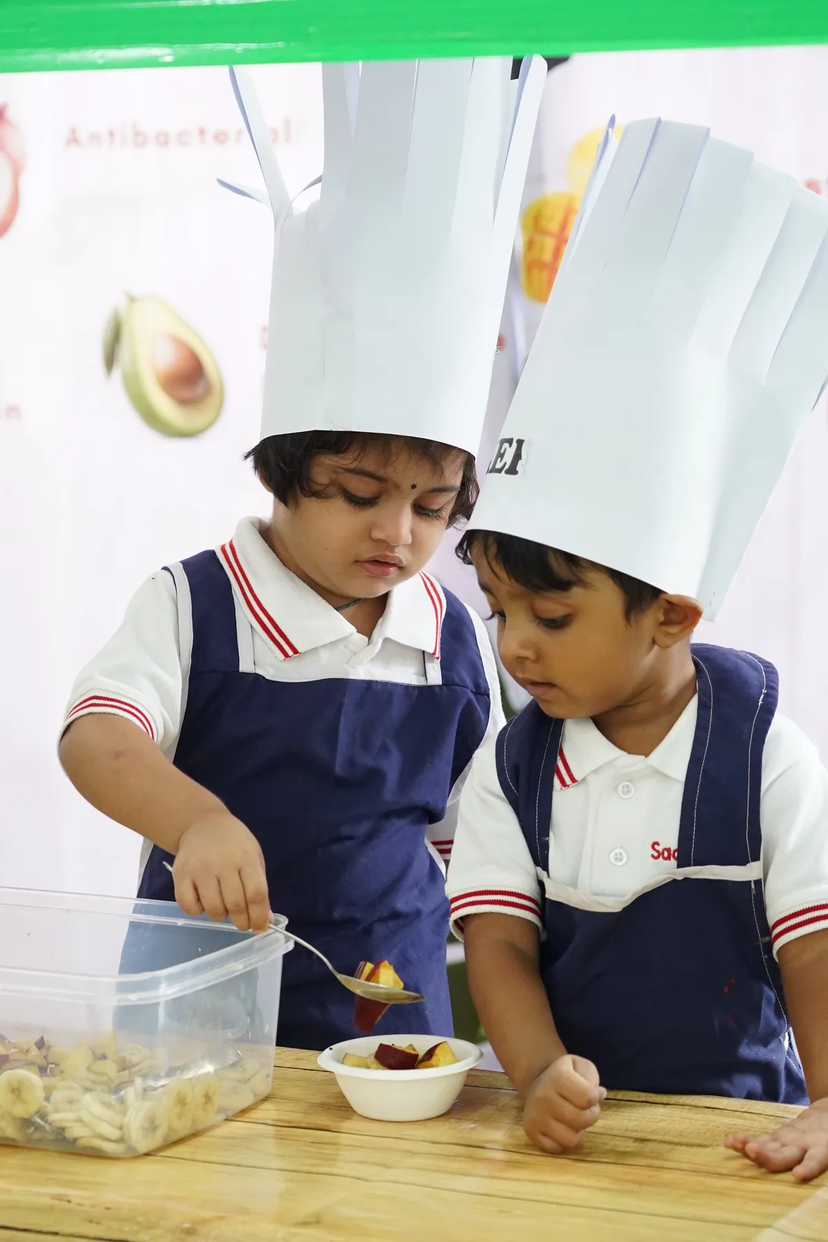 Pre-Primary children in chef hats during a restaurant activity