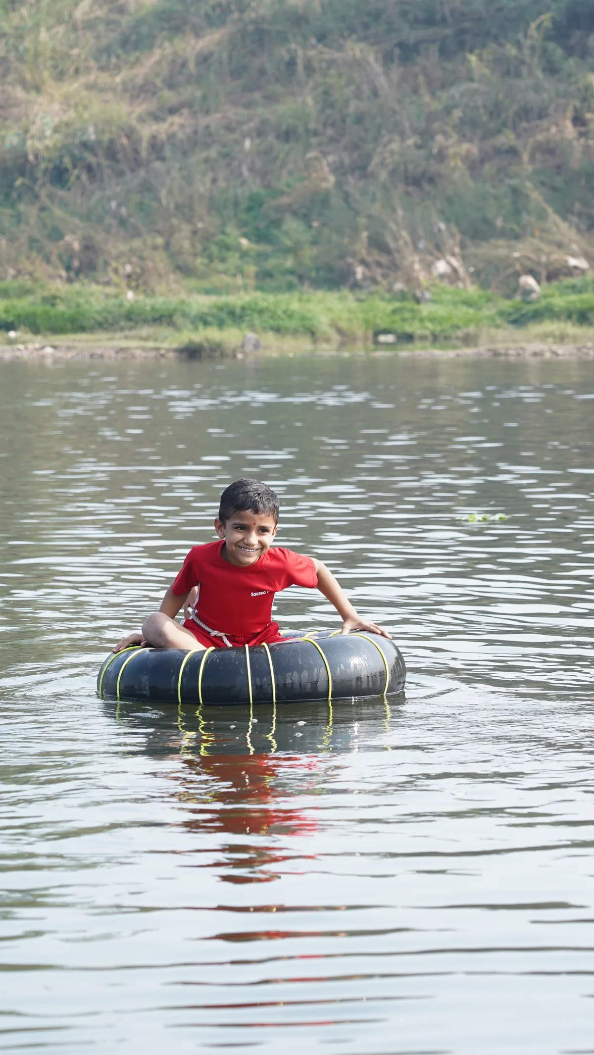 A Pre-Primary child tubing on a river during a field trip