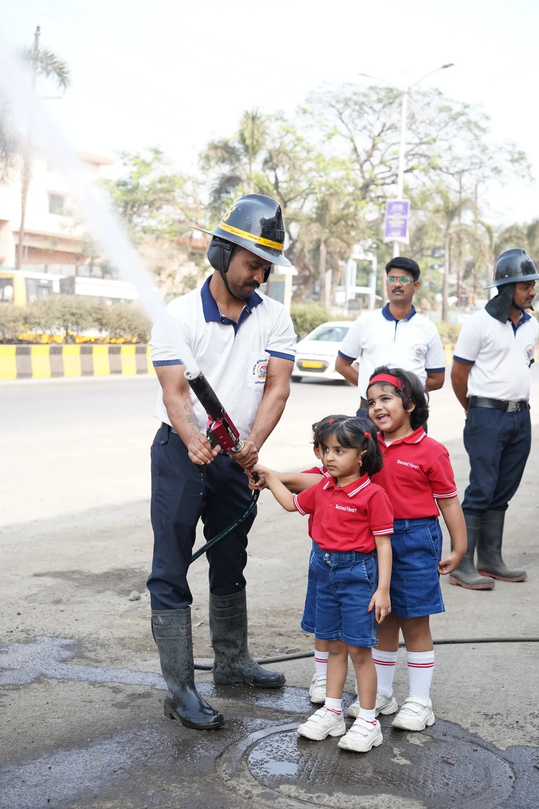 Pre-Primary children watching a firefighter demonstration as part of community-helper learning