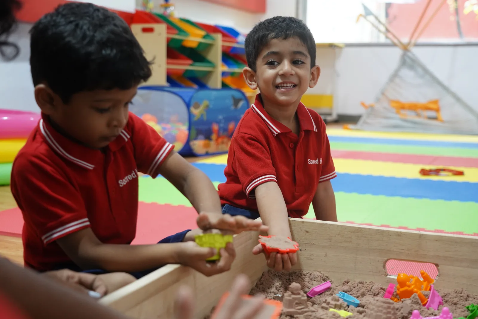 A Pre-Primary child playing in the sandpit