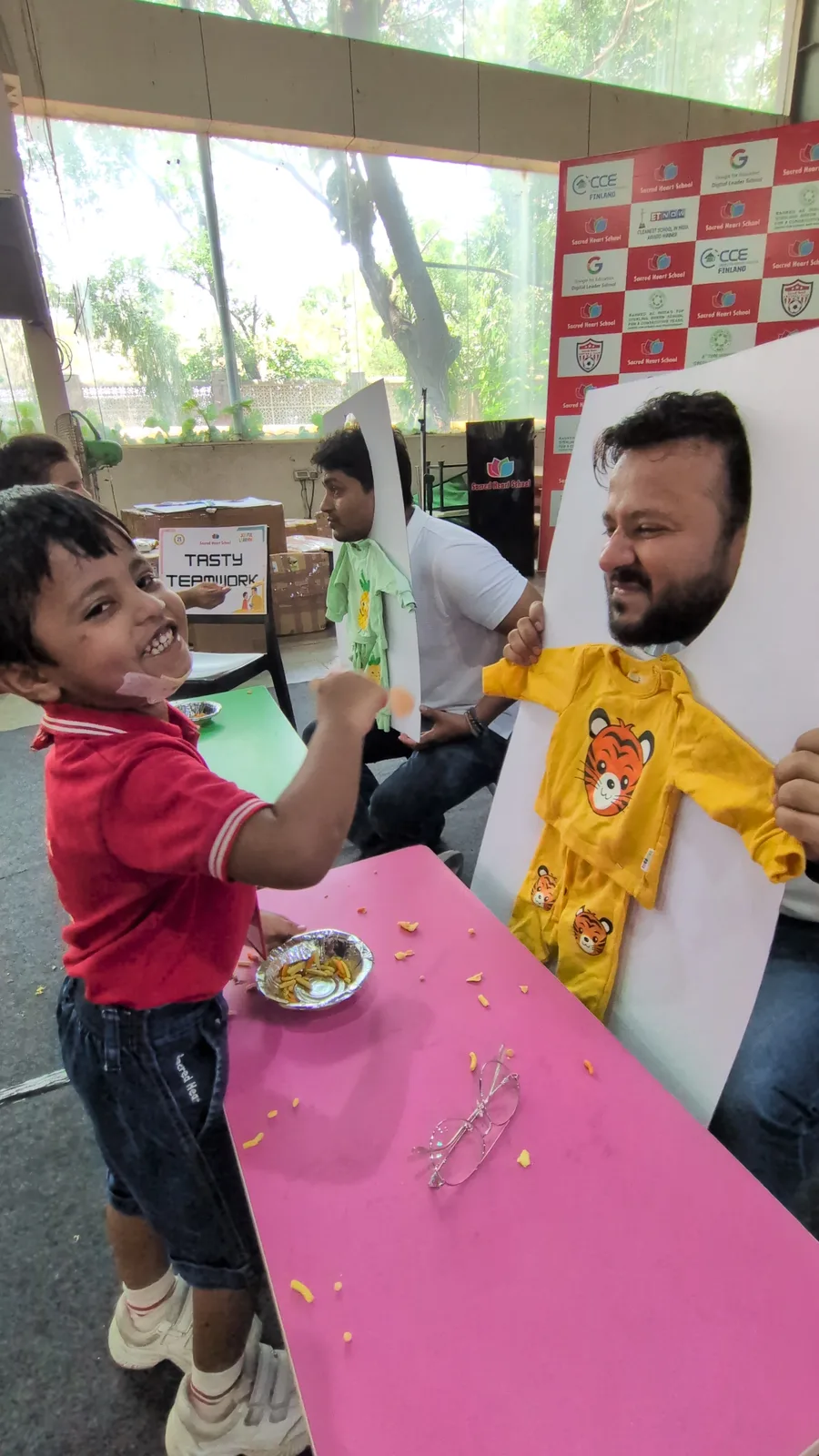 A parent and child painting handprints together