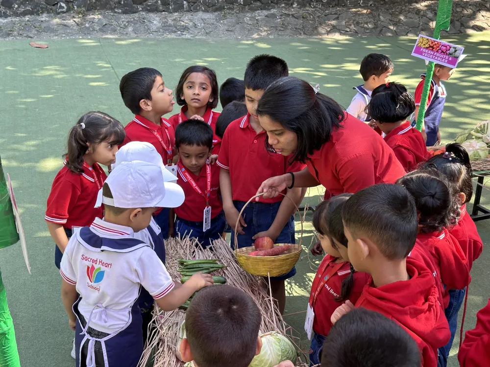Pre-Primary children gathered around a market stall