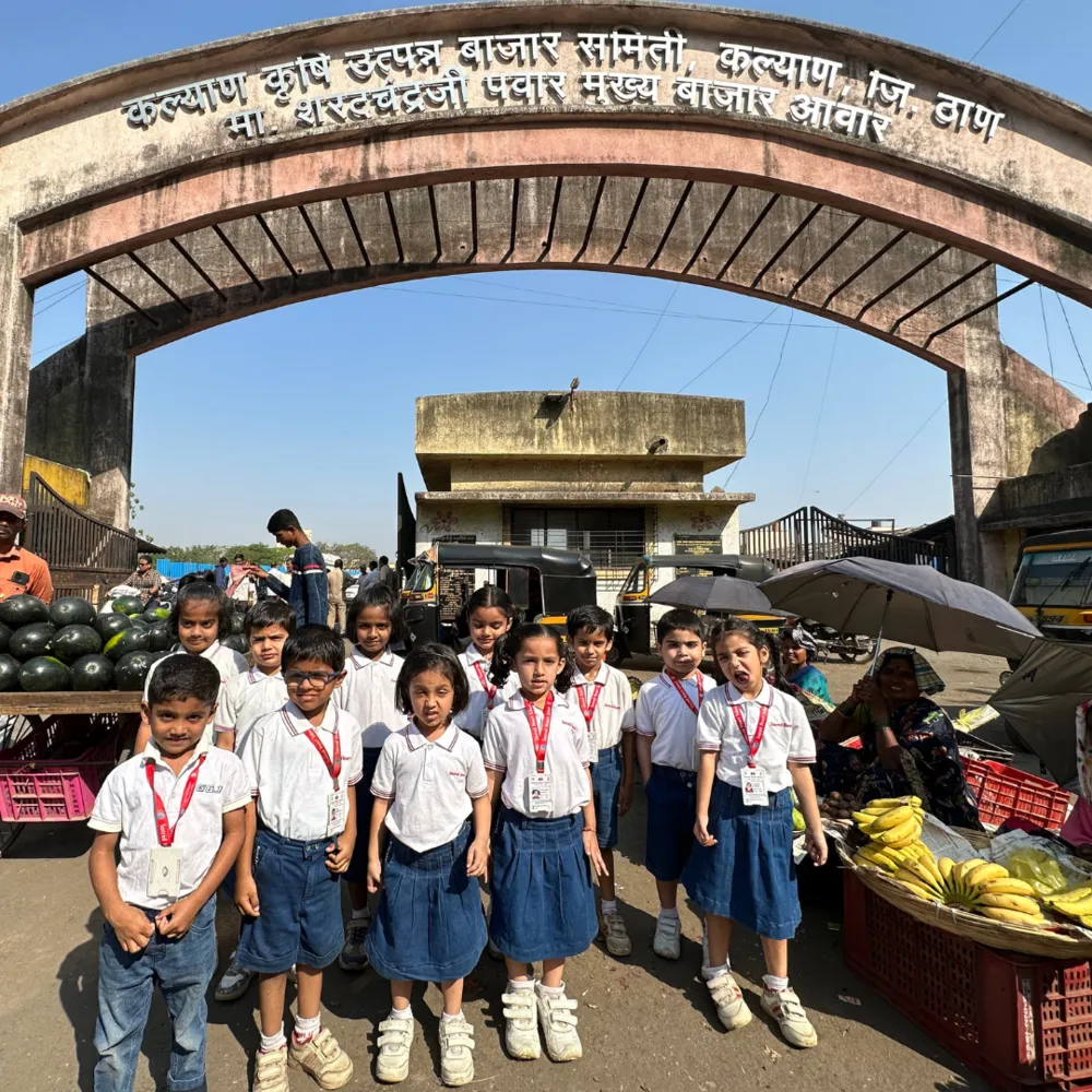 Pre-Primary children posing at the entrance of a wholesale market