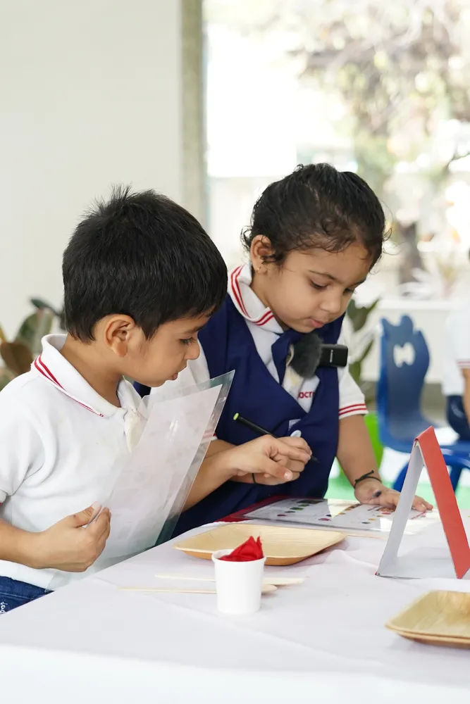 Two children preparing food during the restaurant activity