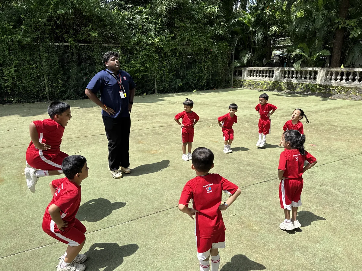Pre-Primary children doing warm-up exercises on the field