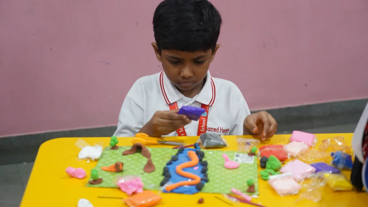 A Primary student shaping a clay model at the Clay Modelling Competition