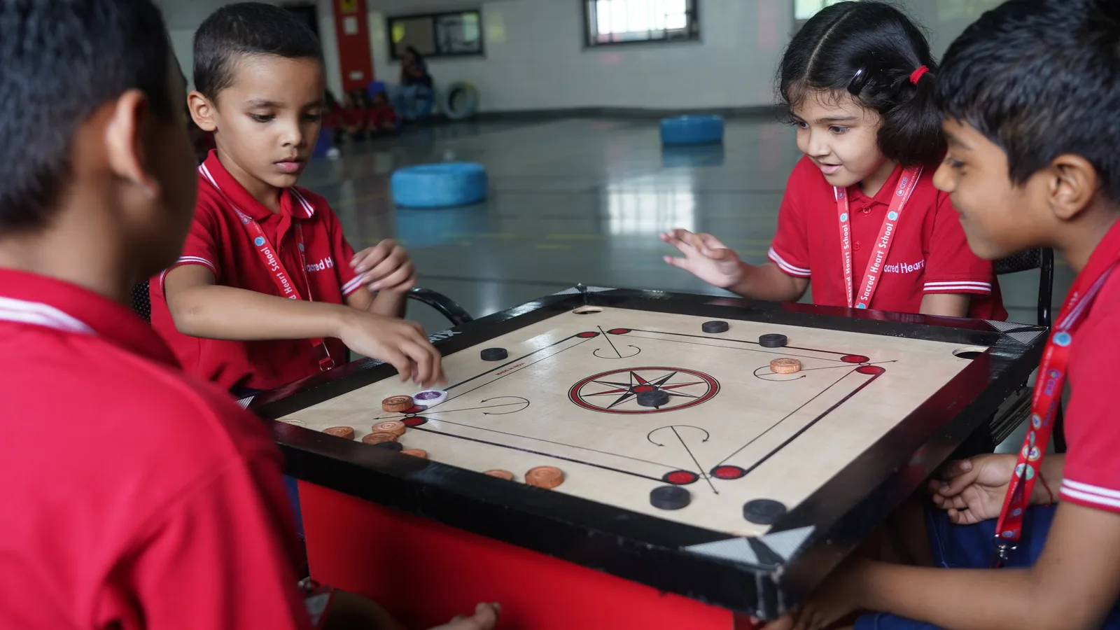 Primary students playing football on the turf