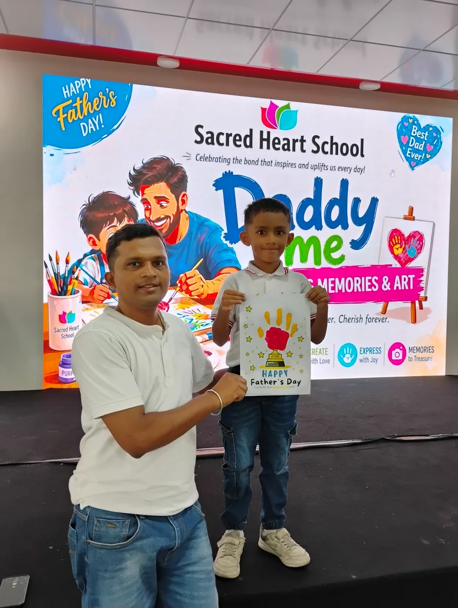 A father and child in front of the Daddy & Me backdrop
