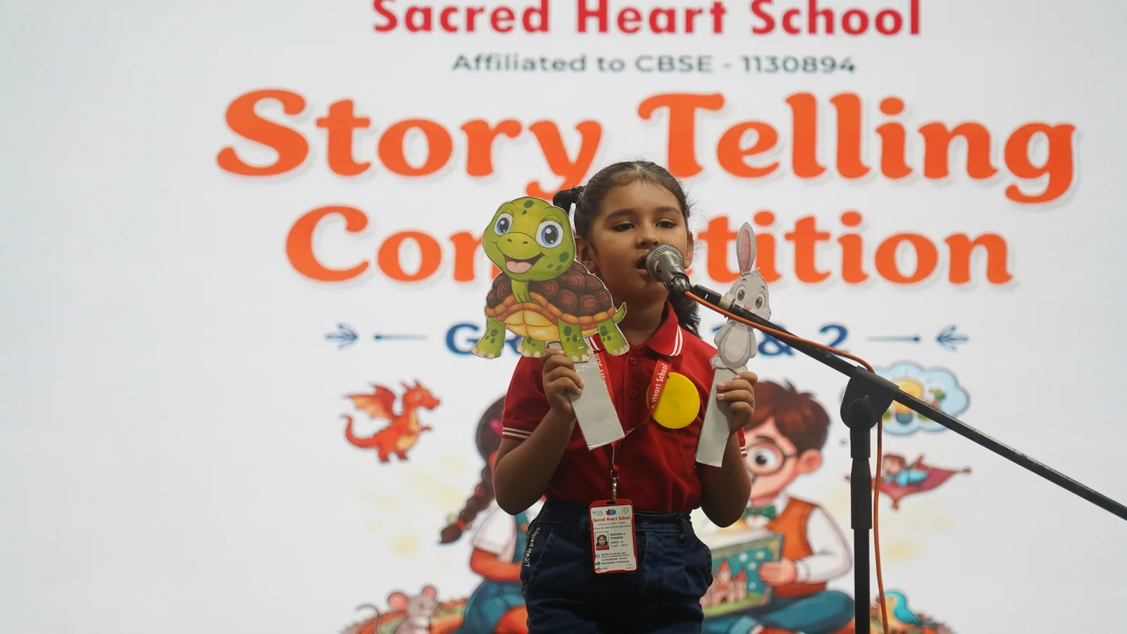 A Primary student narrating with a puppet at the Story Telling Competition