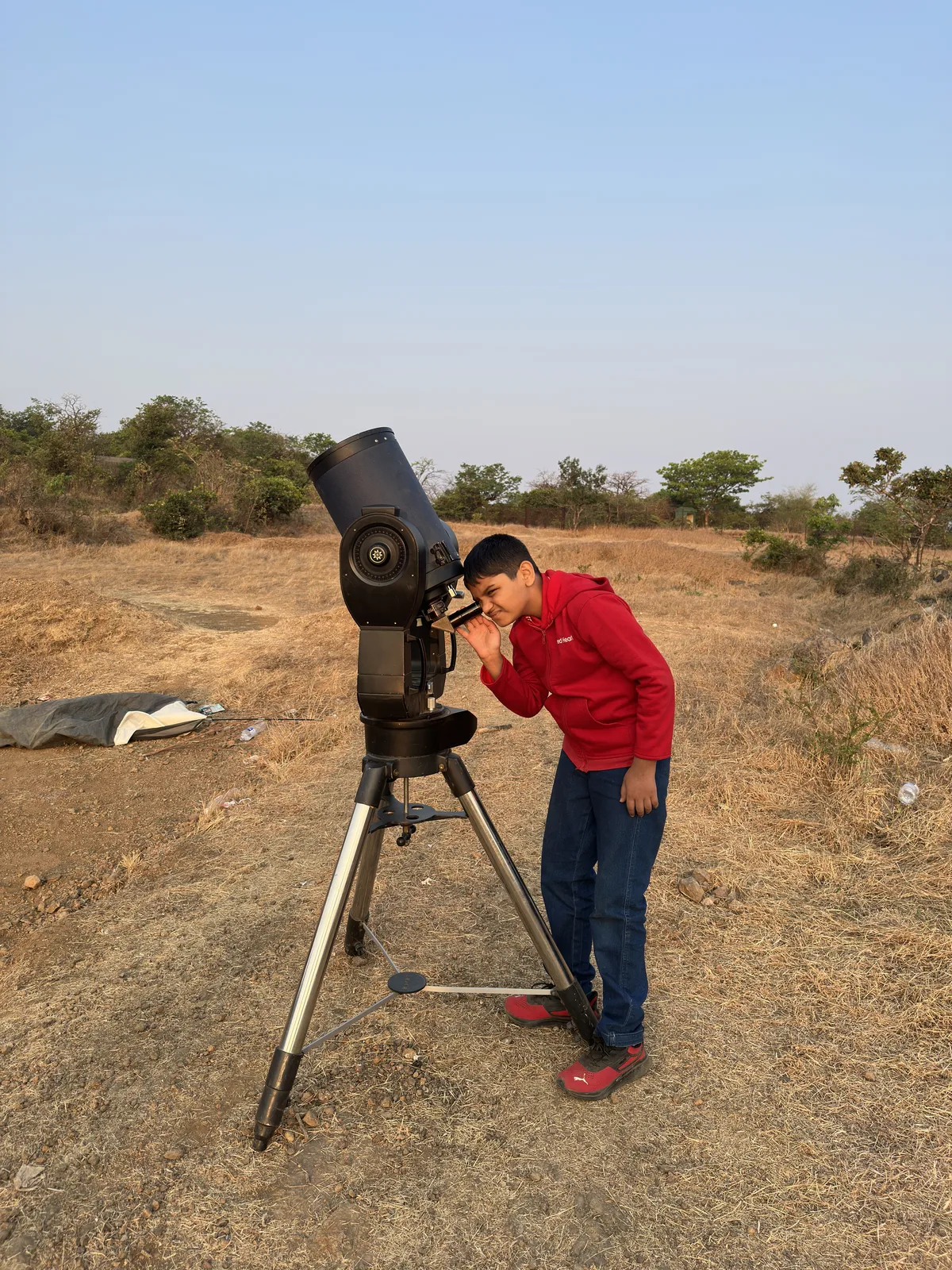 A Secondary student using a telescope during the Astronomy elective
