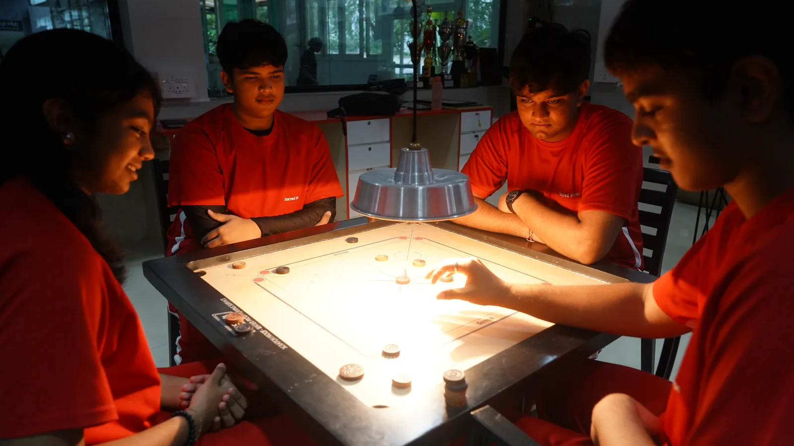 Students playing carrom