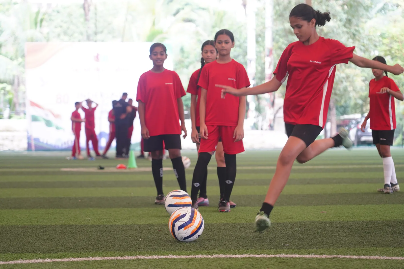 Students playing football on the turf