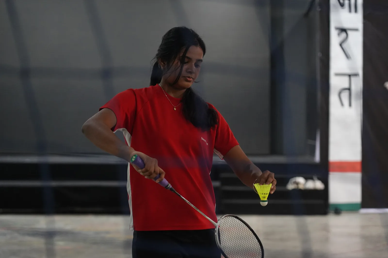 A student playing a badminton forehand