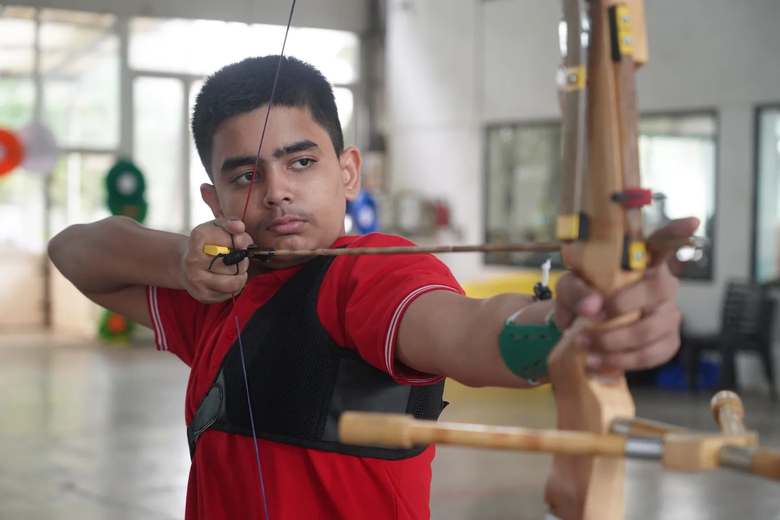 A student at full draw during archery practice