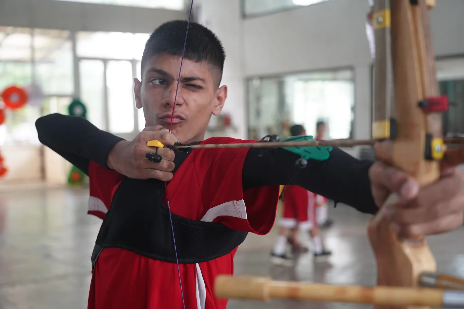 A coach guiding students during a training session