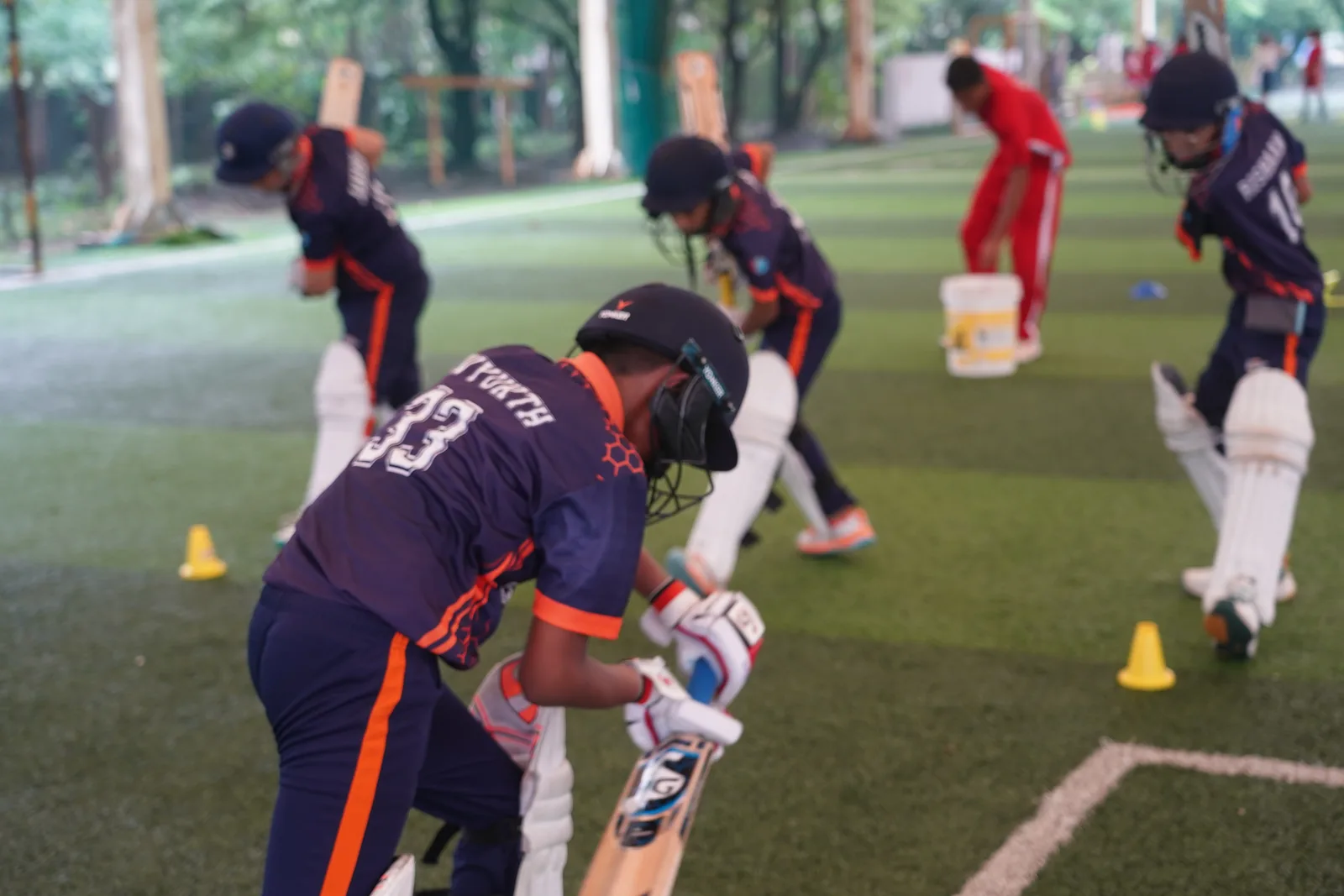 Students practicing cricket in the nets