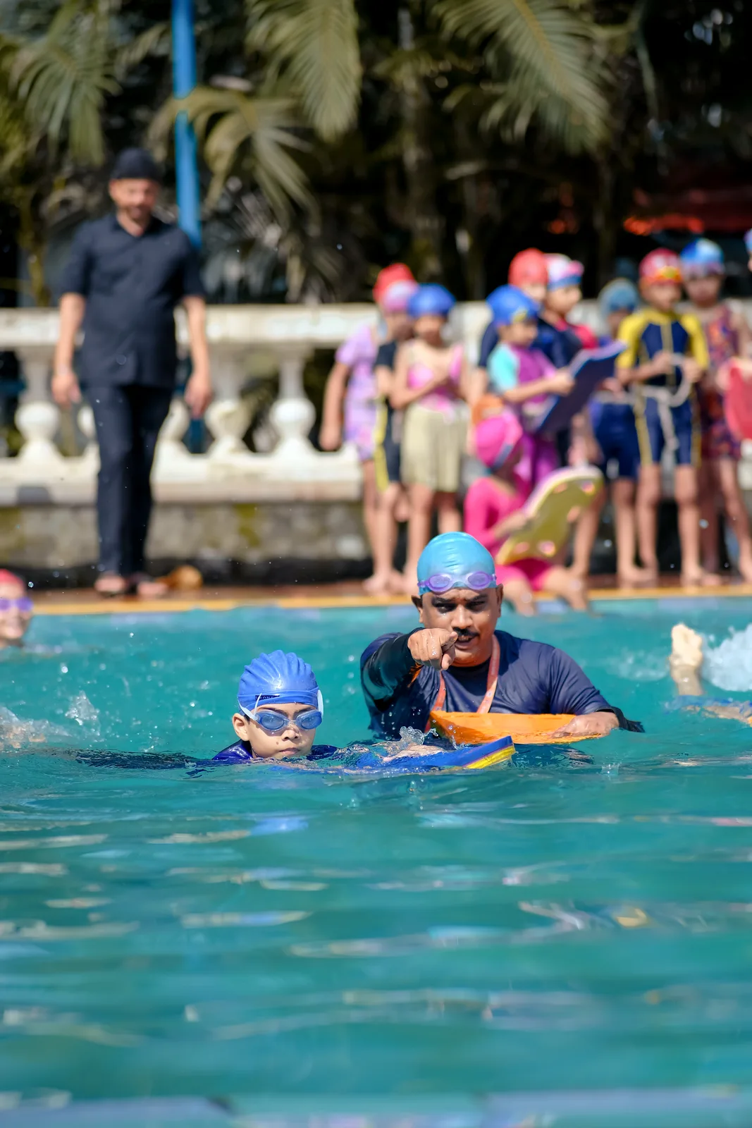 Students lined up poolside before a swimming session
