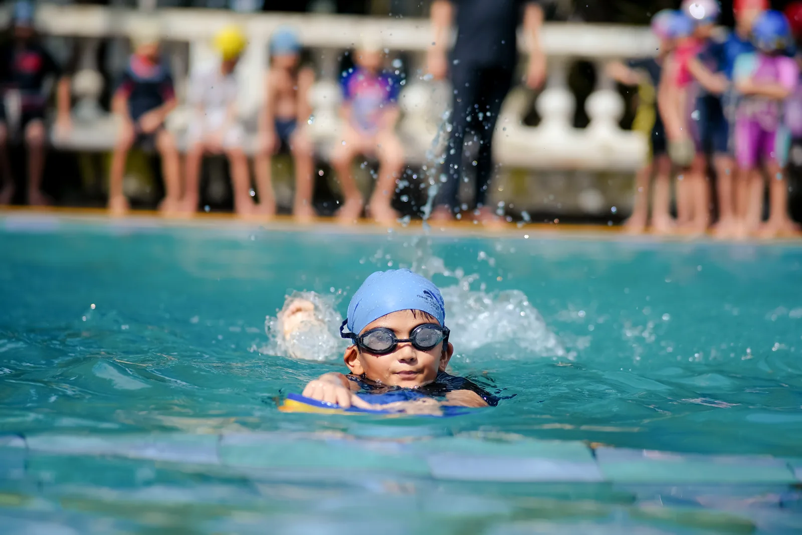 A student swimming freestyle during a coaching session